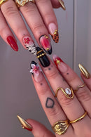 Close-up of a hand with intricately designed nails and gold rings, Obroi