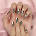 Hand with metallic gold nail polish on a pink background, Obroi