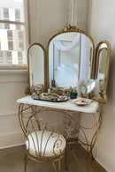 Vintage-style vanity table with three mirrors and decorative items in a room, Obroi