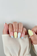 Nails with colorful striped design on a neutral background, Obroi