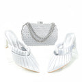 White high-heeled shoes with a matching handbag on a white background, Obroi