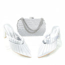 White high-heeled shoes with a matching handbag on a white background, Obroi
