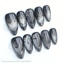 Set of silver metallic nail tips with decorative patterns on a white background, Obroi