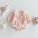 Pink baby romper with lace details on a white background, Obroi
