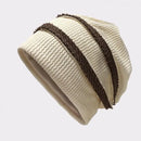 Beige knit beanie with brown stripe on a light gray background, Obroi