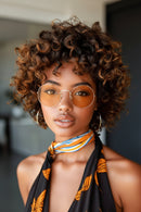 Woman wearing sunglasses and a colorful scarf with a blurred background, Obroi