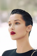 Woman with styled hair and red lipstick against a blurred background, Obroi