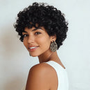 Woman with styled black hair wearing a white top against a light background, Obroi