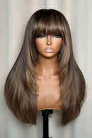 Brown wig with bangs on a mannequin head against a neutral background ,Obroi