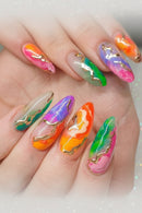 Multicolored nail art with gold accents on a hand, Obroi