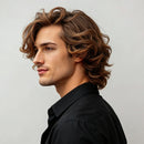Man with styled hair wearing a black shirt against a light gray background, Obroi