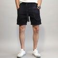 Person wearing black shorts with a belt against a white background, Obroi