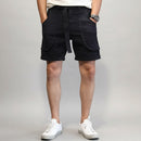 Person wearing black shorts with a belt against a white background, Obroi