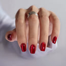 Hand with red nail polish on a light gray background, Obroi