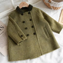 Green coat with black buttons on a white surface, Obroi