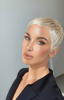 Woman with short blonde hair wearing a black outfit against a gray background, Obroi