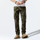 Person wearing camouflage cargo pants on a white background, Obroi
