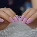 Close-up of hands with pink nail polish on a textured surface ,Obroi