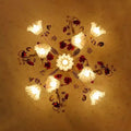 Decorative ceiling light fixture with floral design on a beige wall, Obroi