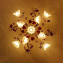Decorative ceiling light fixture with floral design on a beige wall, Obroi