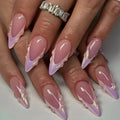 Close-up of hands with pink and purple nail design on a neutral background, Obroi