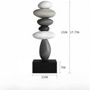 A black rectangular base supporting a stacked stone sculpture in white, light gray, medium gray, and dark gray tones. Measurement annotations show the overall height as 38 cm plus 45 cm, a base width of 15 cm, a base depth of 7 cm, and a side dimension of 15 cm, Obroi