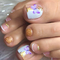 Toe nails with butterfly and glitter design on a neutral background, Obroi