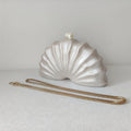 Shell-shaped clutch with a gold chain on a light background, Obroi