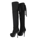 Black knee-high boots with decorative laces and chain details on a white background, Obroi