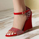 Red wedge sandal with embellishments on a neutral background, Obroi