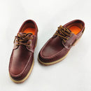 Pair of brown leather shoes with orange soles on a white background, Obroi