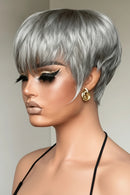 Woman with stylish silver hair and gold earrings against a neutral background, Obroi