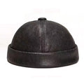 Black leather cap on a white background, Obroi