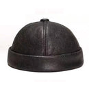 Black leather cap on a white background, Obroi