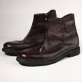 Pair of brown leather boots with buttons on a white background, Obroi