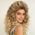 A woman wearing a voluminous, curly wig with a blonde ombre transition, photographed against a plain light background, Obroi