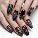 A close-up of manicured fingernails on a hand, featuring a gothic Halloween theme with black and deep purple gradients, silver spiderwebs, rhinestones, and star details, Obroi