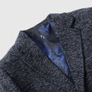Close-up of a textured gray blazer with a blue satin lining, featuring the Obroi brand.