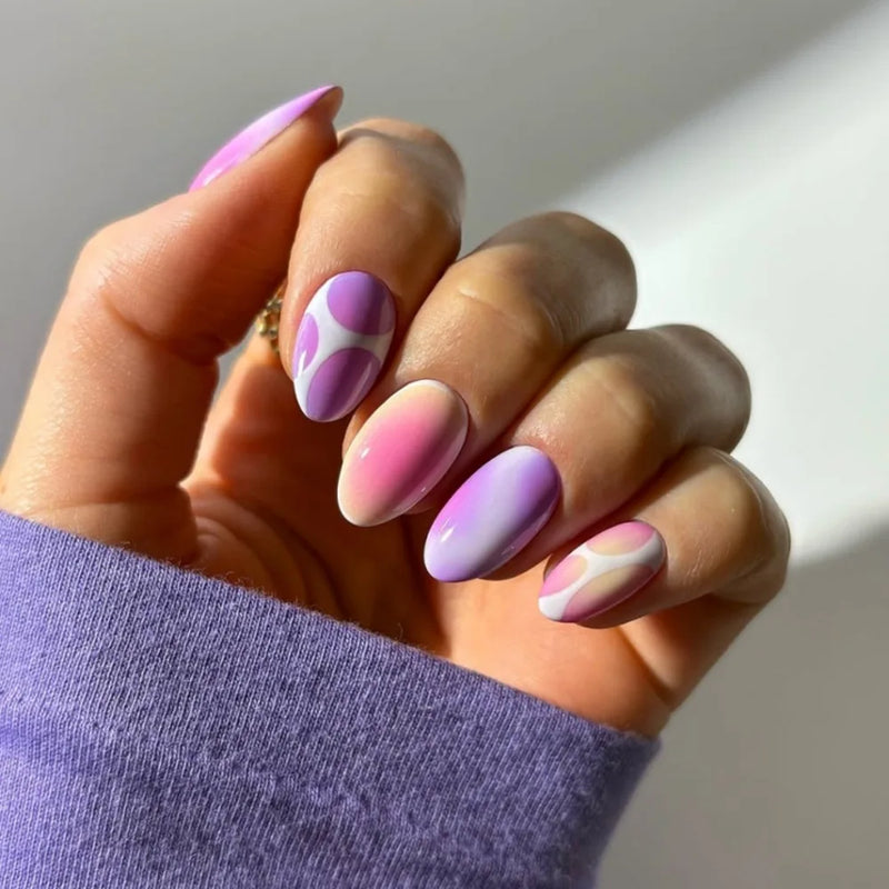Hand with pink and purple gradient nails on a neutral background, Obroi