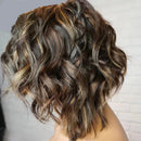 Short, wavy bob haircut with highlighted brown, ash brown, and blonde tones, shown from the back on a mannequin head against a light gray brick wall background, Obroi