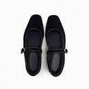 Pair of black flat shoes with a strap on a white background, Obroi