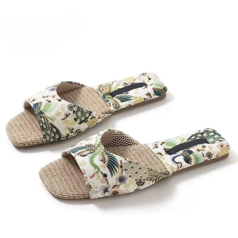 Pair of floral-patterned slippers with jute sole on a white background, Obroi