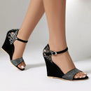 Black wedge sandals with rhinestone details worn by a person on a neutral background, Obroi