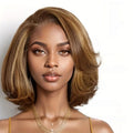 Woman with styled hair and gold jewelry on a white background, Obroi