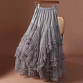 Gray lace skirt on a hanger against a brown background, Obroi