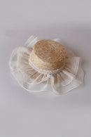 Woven straw hat with pearl embellishments on a light gray background, Obroi