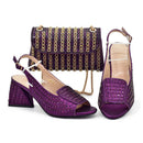 Purple high-heeled shoes and matching handbag with gold accents on a white background, Obroi