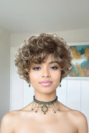 Woman with styled hair and a necklace in a neutral setting, Obroi