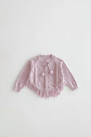 Pink knitted sweater with tassels on a light gray background, Obroi