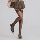 Obroi Person wearing a brown skirt and black polka dot tights on a gray background